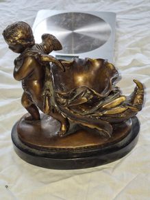 Bronzed Winged Cherub putto open seashell or leaf-shaped vessel with a scorpion like tail.