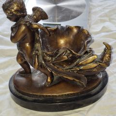 Bronzed Winged Cherub putto open seashell or leaf-shaped vessel with a scorpion like tail.