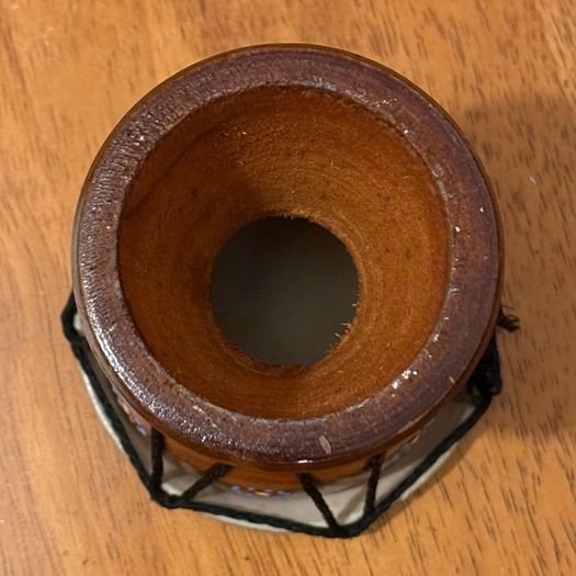 This is a small hand-carved Australian drum with a hand-painted turtle design