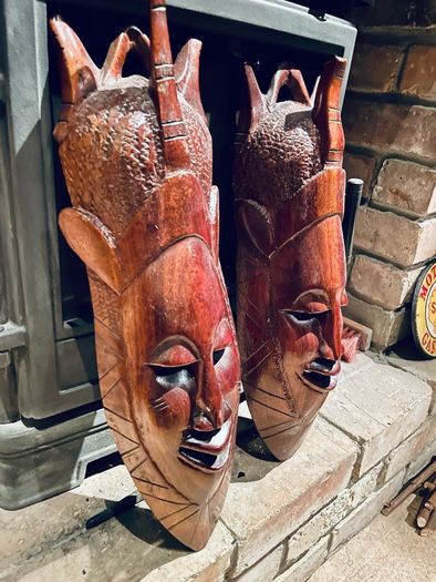 Two carved tribal masks
