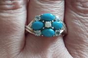 A 925 sterling silver ring with turquoise, opal, and topaz.