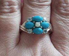 A 925 sterling silver ring with turquoise, opal, and topaz.