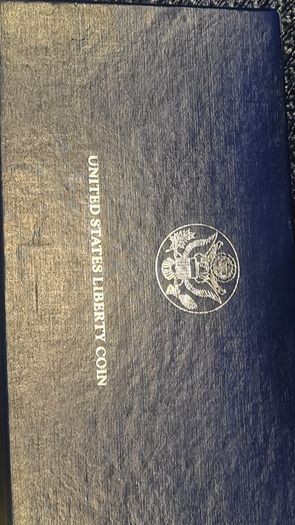American 1986s silver dollar. Ellis Island