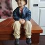 Resin sculpture of a seated boy Image 2