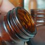 471 - Set of 4 Vintage Amber Glass Screw Top Collectible Decorative Bottles Image 4