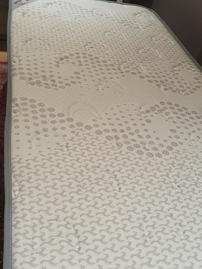 Single divan bed with pristine clean mattress and space for headboard