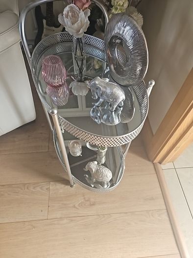 drinks trolly and large flower arrangement with vase