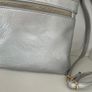 Silver crossbody handbag with contrasting gold zips & hardware  In excellent condition. Purchased in Toulouse Image 9