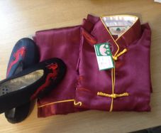 A full set of dark ruby red Chinese Kung Fu Costume with matching black shoes, with tag for boys.
