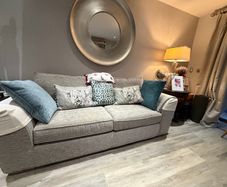 Grey fabric three-seater sofa