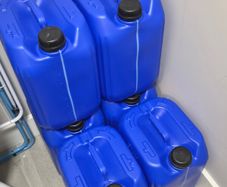 Six 5 gallon drums