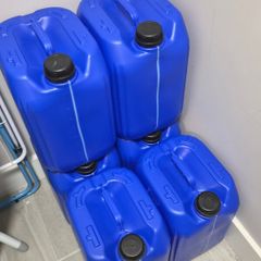 Six 5 gallon drums