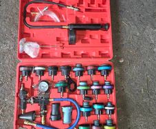 Coolant pressure tester and vacuum bleeder