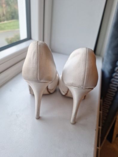 Ivory satin peetoe high heel shoes by Dune London with a pleated bow trim accented with rhinestones