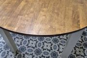 Round wooden dining table with white legs