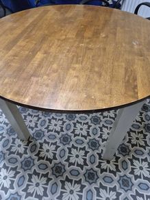 Round wooden dining table with white legs