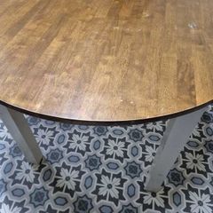 Round wooden dining table with white legs