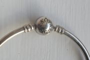 Pandora Moments 925 sterling silver bangle bracelet with a ball clasp.