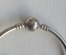 Pandora Moments 925 sterling silver bangle bracelet with a ball clasp.