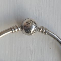 Pandora Moments 925 sterling silver bangle bracelet with a ball clasp.