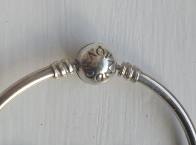 Pandora Moments 925 sterling silver bangle bracelet with a ball clasp.