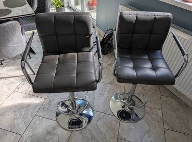 Pair of grey faux leather bar stools with chrome base