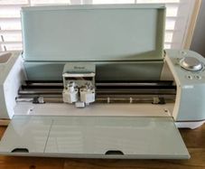 Cricut machine explore air 2 with 3 large rolls of vinyl, mats