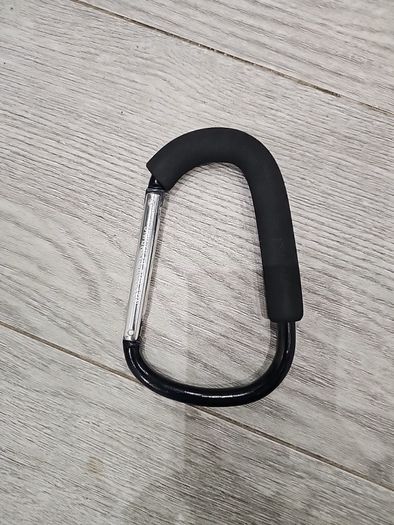 Large D-shape carabiner-style stroller hook with a foam grip also known as a buggy clip, mummy clip, or pram hook