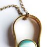 Vintage necklace features a polished, knocker-shaped pendant  gold plated, centered with an iridescent turquoise Spinning Fob Image 9