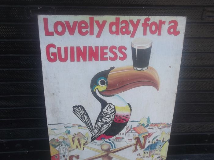 a hand painted perched guinness toucon  on board