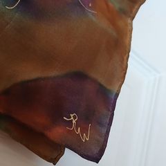 Hand painted, 100% silk scarf featuring a hand-rolled hem and custom metallic gutta detailing.