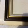 frame A rich dark-wood and gilt picture frame featuring a textured fabric mat liner. Image 2