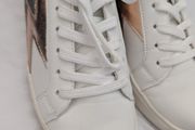 Runners in white with gold and grey lightning bolt on side