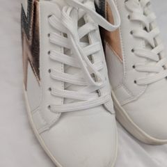 Runners in white with gold and grey lightning bolt on side