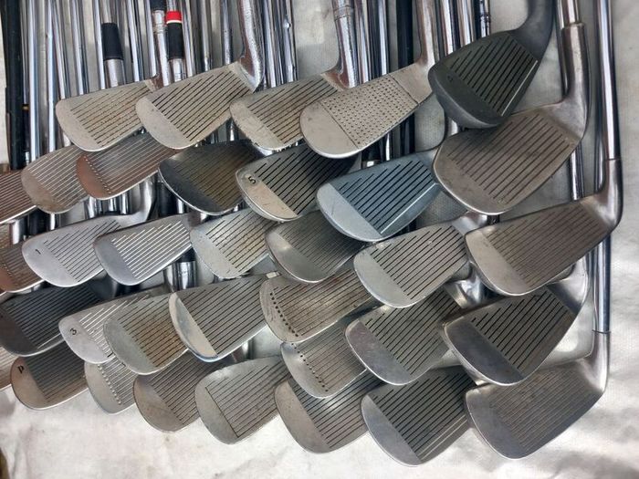 A selection of golf clubs and bags. Golf balls