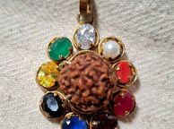 main image for ad Rudraksha seed pendant with natural precious stones ruby emerald sapphire