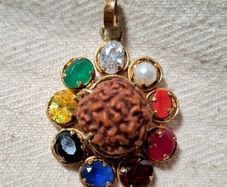 Rudraksha seed pendant with natural precious stones ruby emerald sapphire
