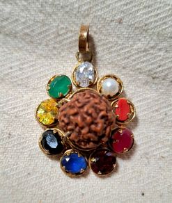 Rudraksha seed pendant with natural precious stones ruby emerald sapphire