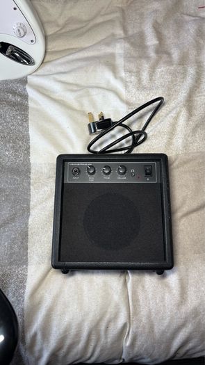 White electric guitar with amp box used only twice