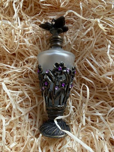 Vintage-style frosted glass perfume bottle.