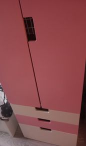 Pink and white children's wardrobe with internal wire baskets