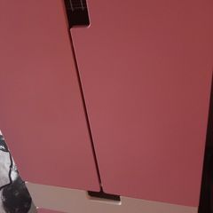 Pink and white children's wardrobe with internal wire baskets
