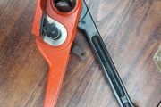 Tensioner for plastic strap