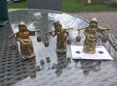 3 brass figures with water buckets, D18 post 7e