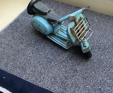Vintage blue metal model of a Vespa