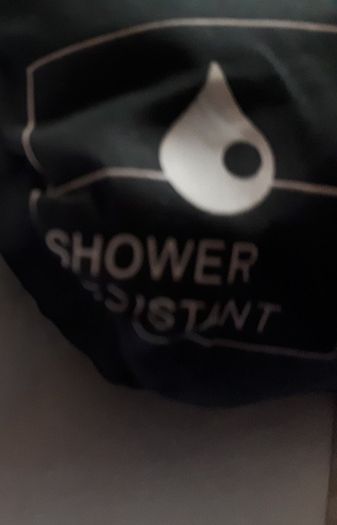 New rain coat with tag attached
