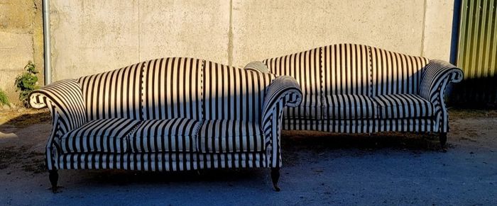 Vintage pair of camelback sofas