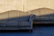 Vintage pair of camelback sofas