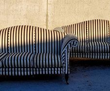 Vintage pair of camelback sofas