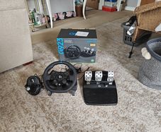 Logitech G923 Wheel with pedals and shifter.